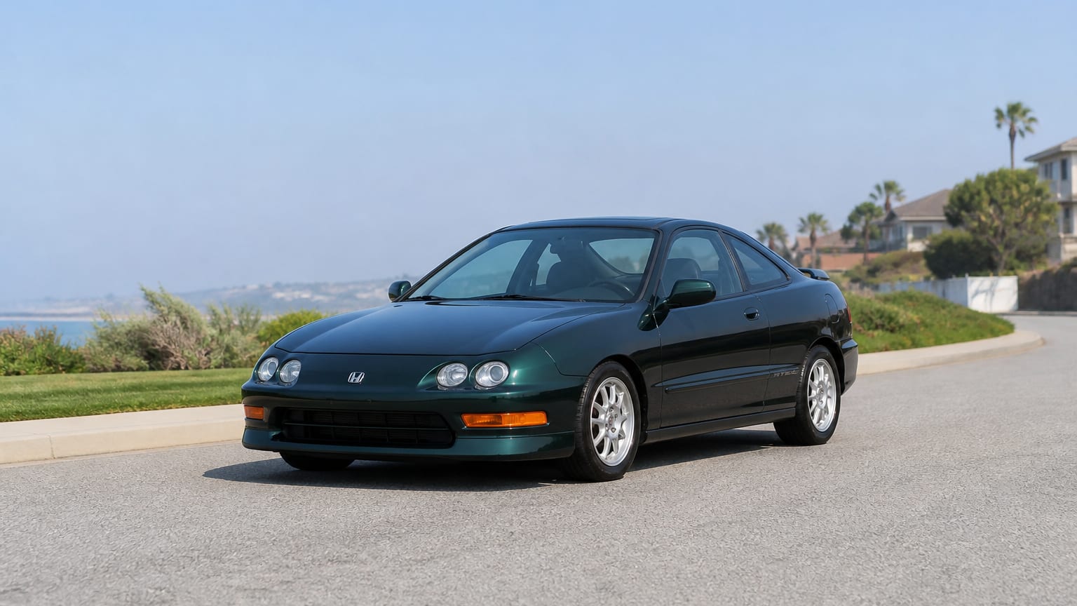 A cleaner later-model Acura Integra on a quiet road.