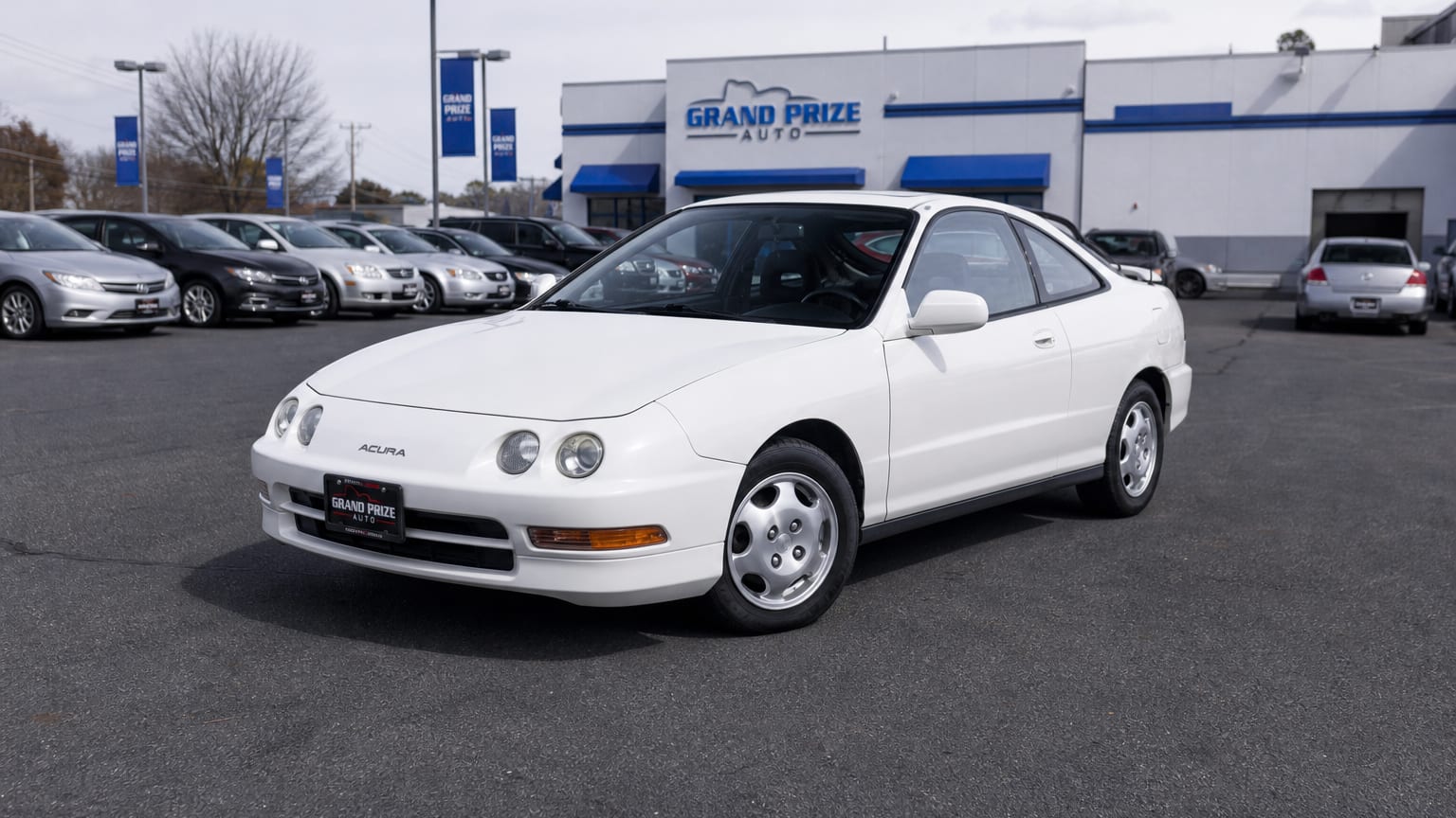 A higher-risk Acura Integra model year parked in a dealership lot.