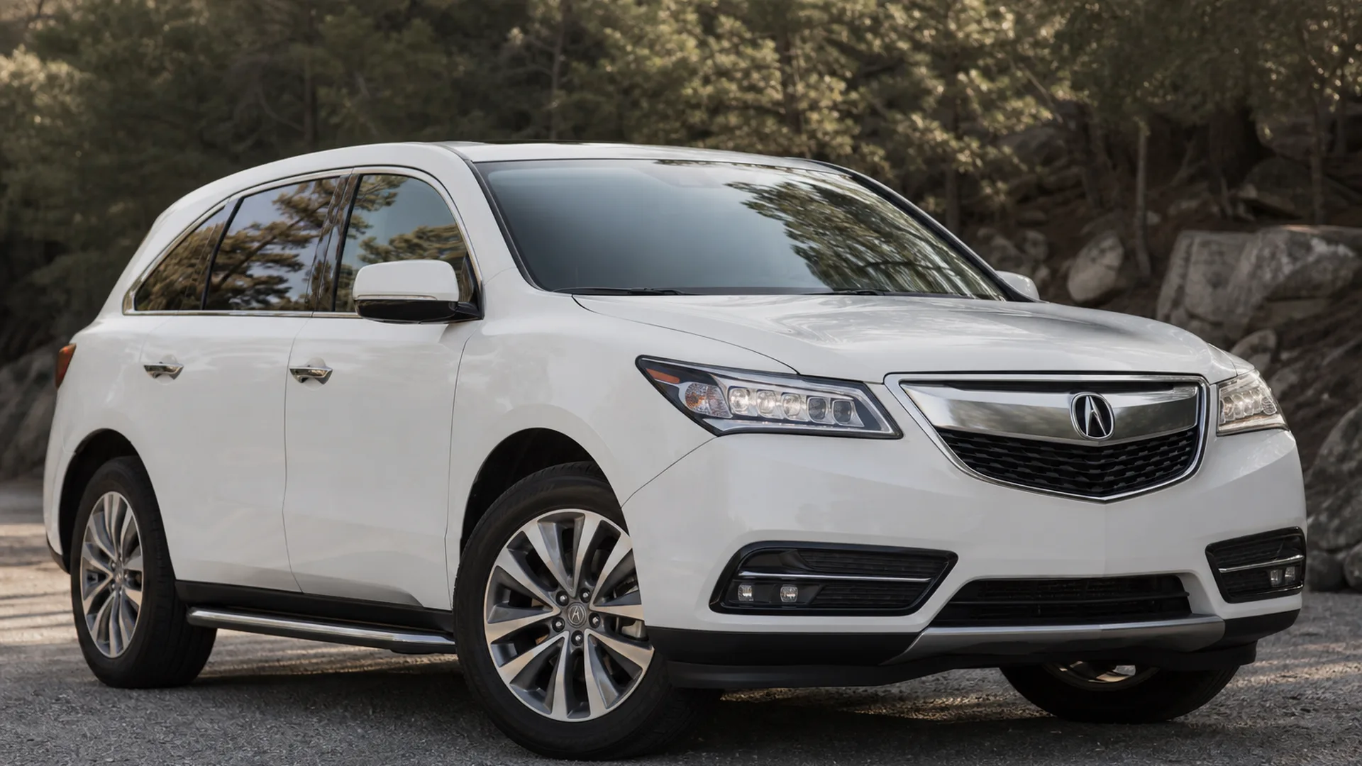 A white Acura MDX SUV parked outdoors.