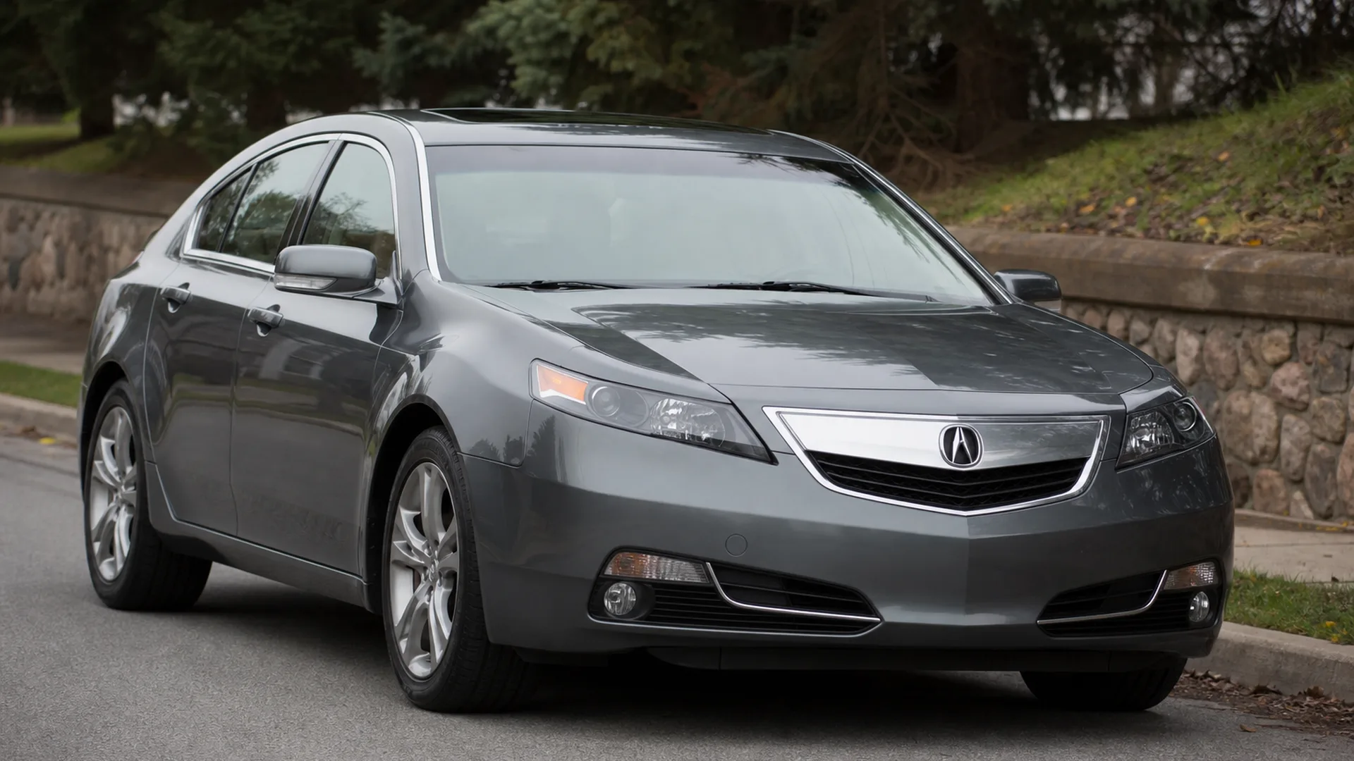 A grey Acura TL sedan parked on a street.
