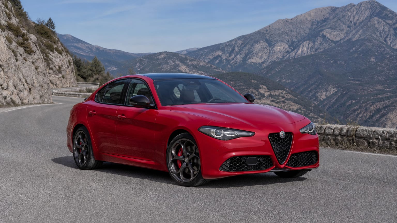 A cleaner later-model Alfa Romeo Giulia on a quiet road.