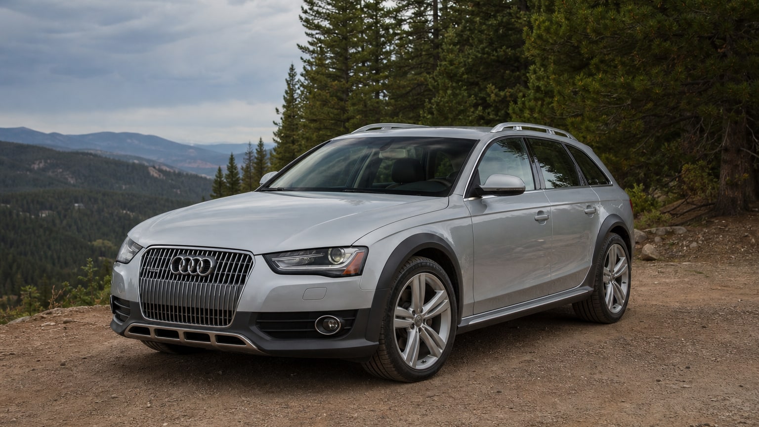 A silver Audi Allroad wagon parked at a trailhead overlook.