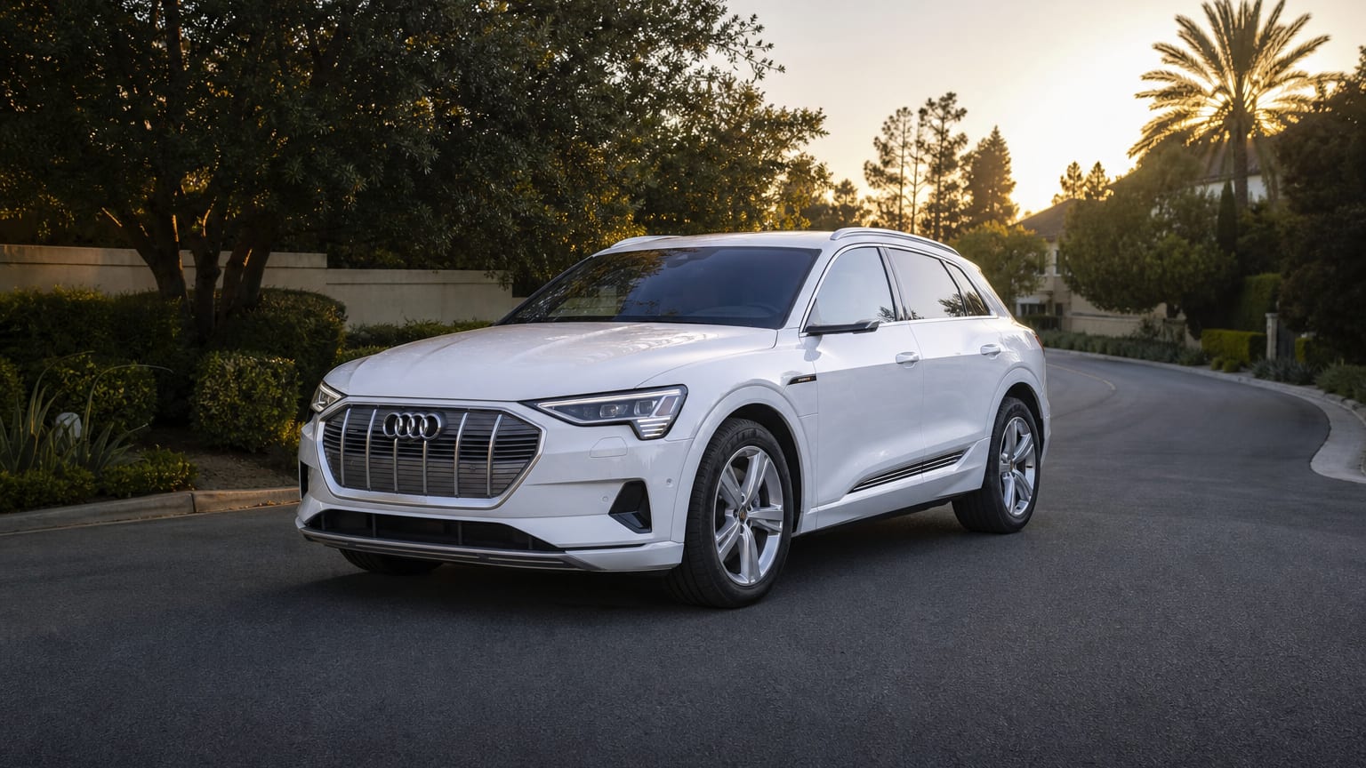 A late-model 2020–2021 Audi e-tron on a quiet residential street.
