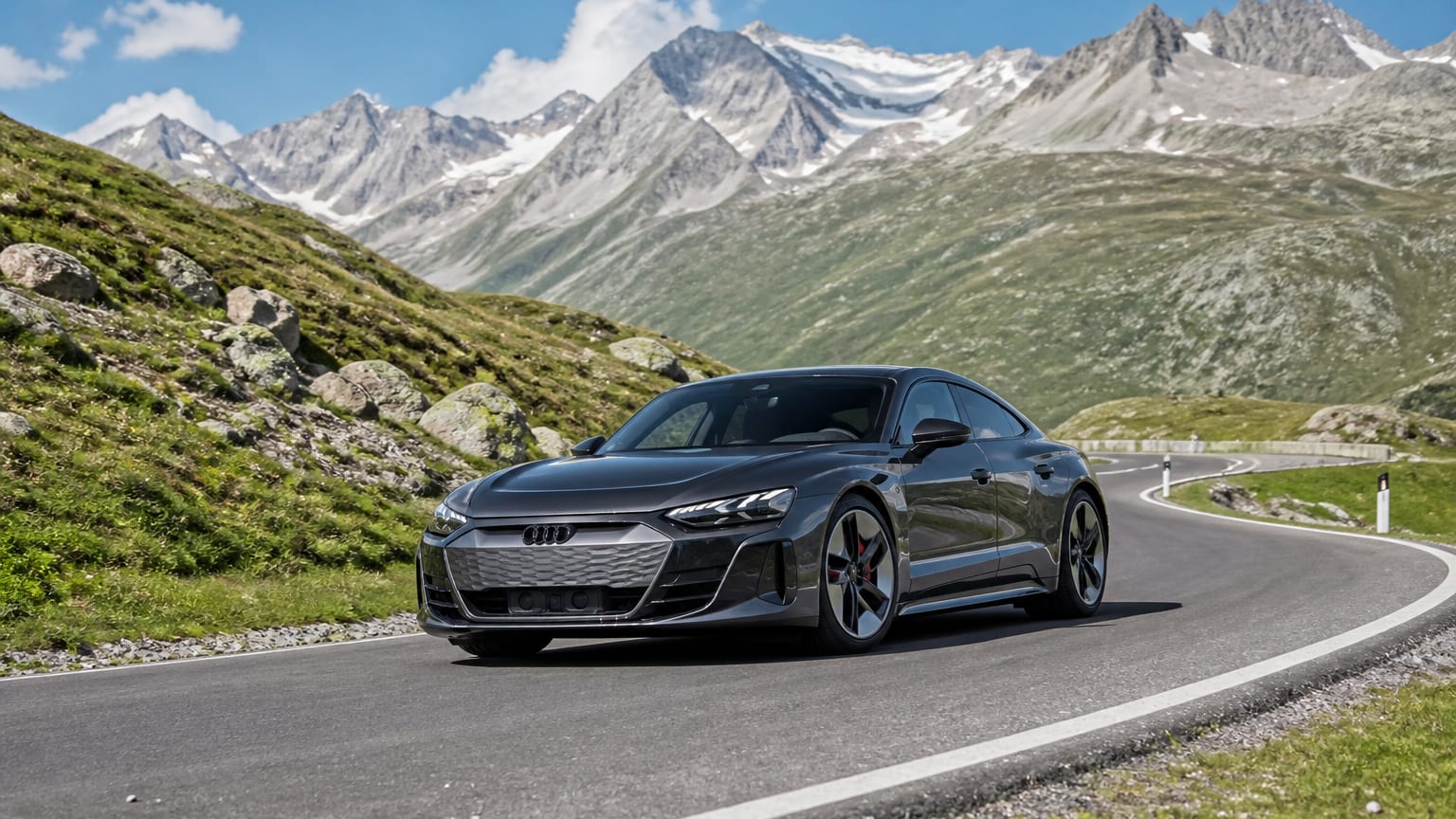 A late-model 2024–2025 Audi e-tron GT on a mountain road.