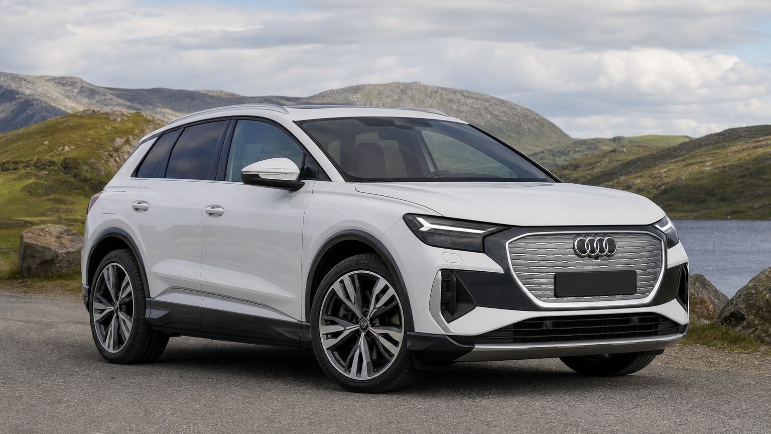 A cleaner later-model Audi Q4 e-tron on a quiet road.