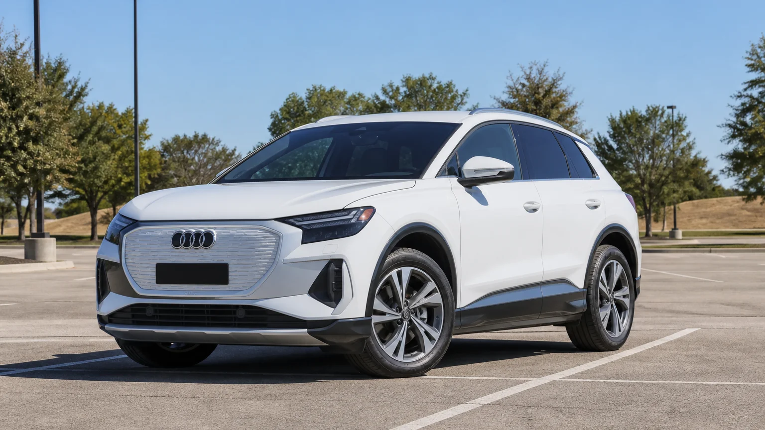 A Audi Q4 e-tron, three-quarter front view, parked outdoors.
