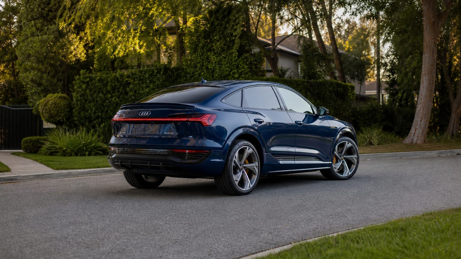 A late-model 2024–2025 Audi Q8 e-tron on a quiet residential street.