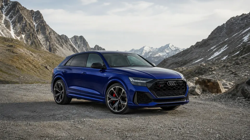 A Navarra Blue Audi RS Q8 performance SUV, three-quarter front view, parked in the mountains.