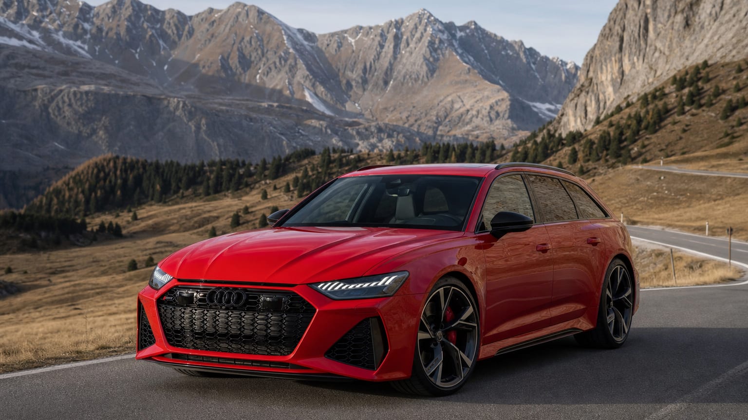 A late-model 2022–2023 Audi RS6 Avant on a scenic alpine road.