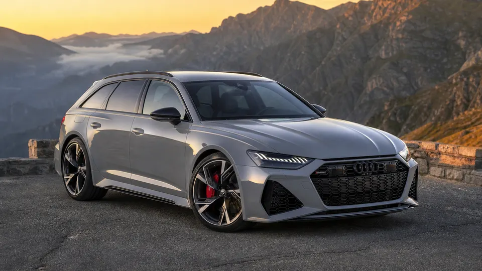 A Nardo Gray Audi RS6 Avant wagon, three-quarter front view, parked on a mountain overlook.