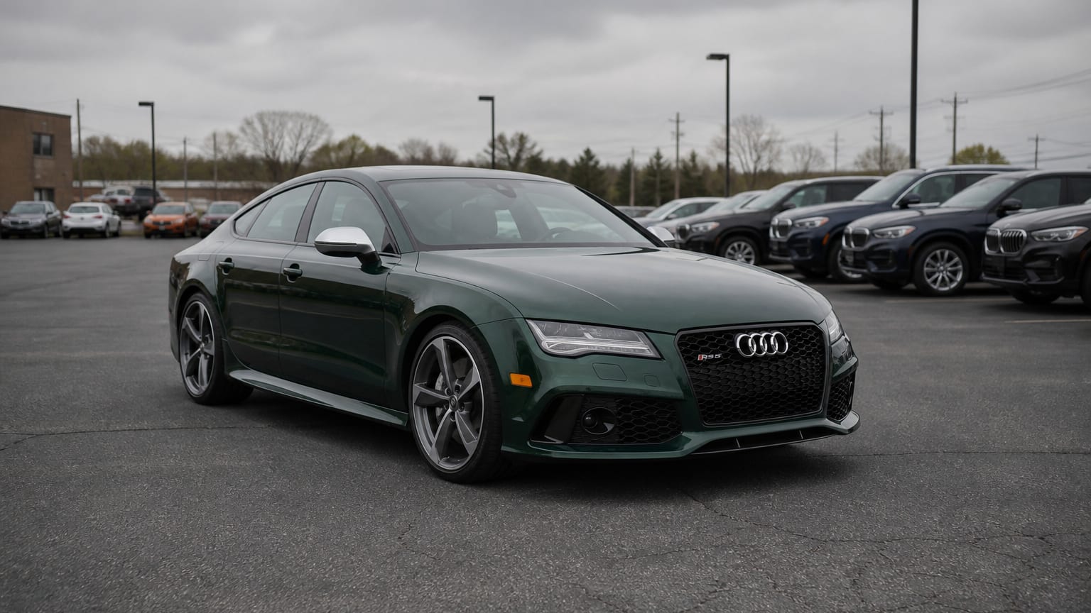 A dark green 2015 Audi RS7 parked in a dealership lot.