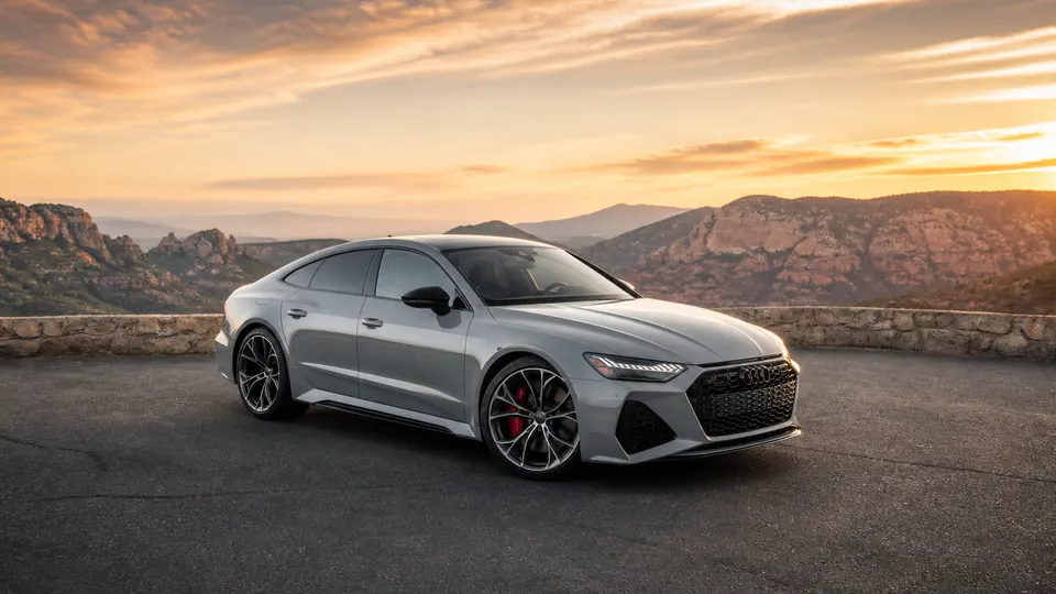 A Nardo Gray Audi RS7 Sportback, three-quarter front view, parked on a canyon overlook.