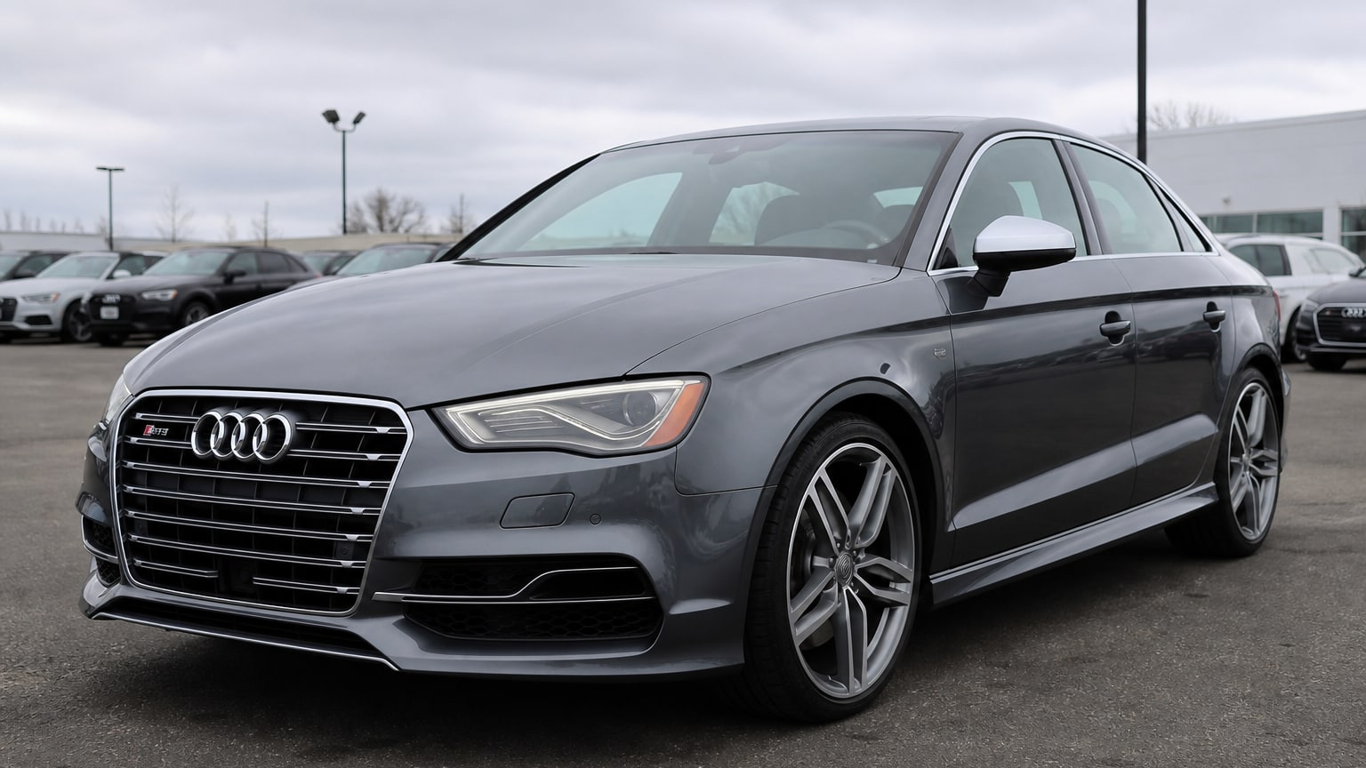 A gray 2015–2016 Audi S3 parked in a dealership lot.