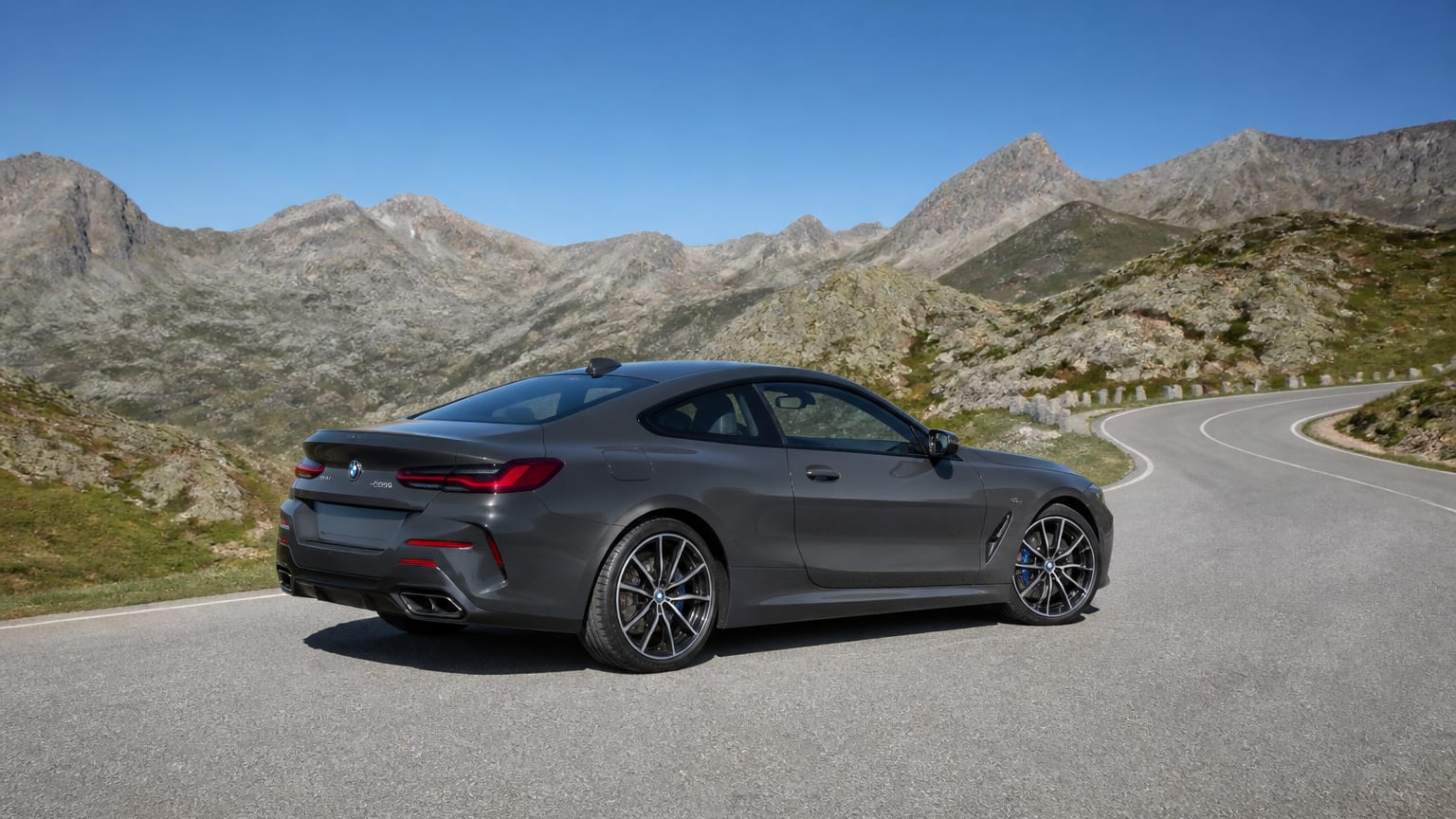 A late-model 2022–2023 BMW 4 Series coupe on a mountain road.