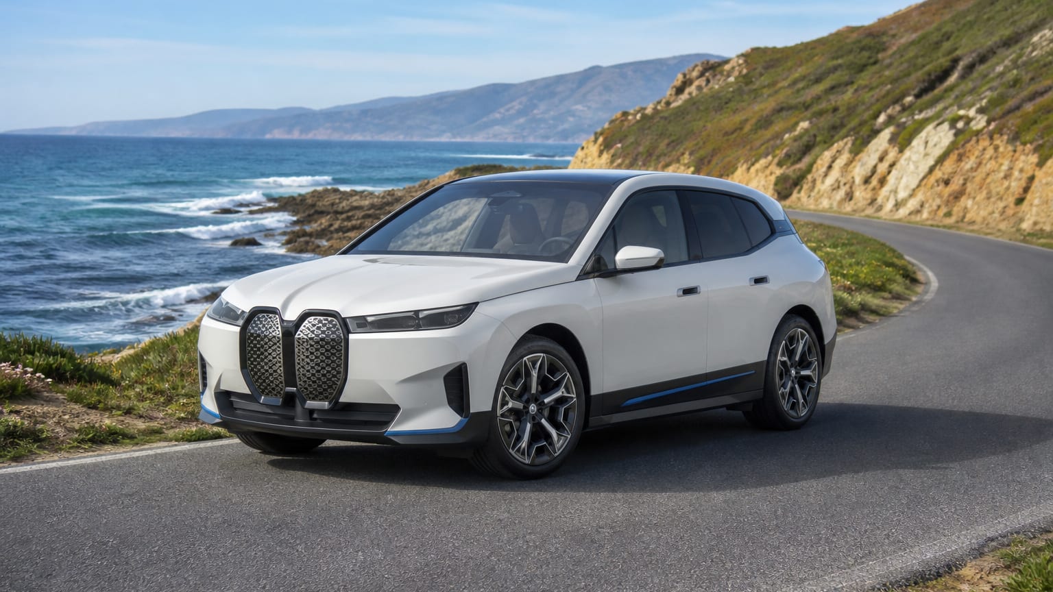 A cleaner later-model BMW iX on a quiet road.