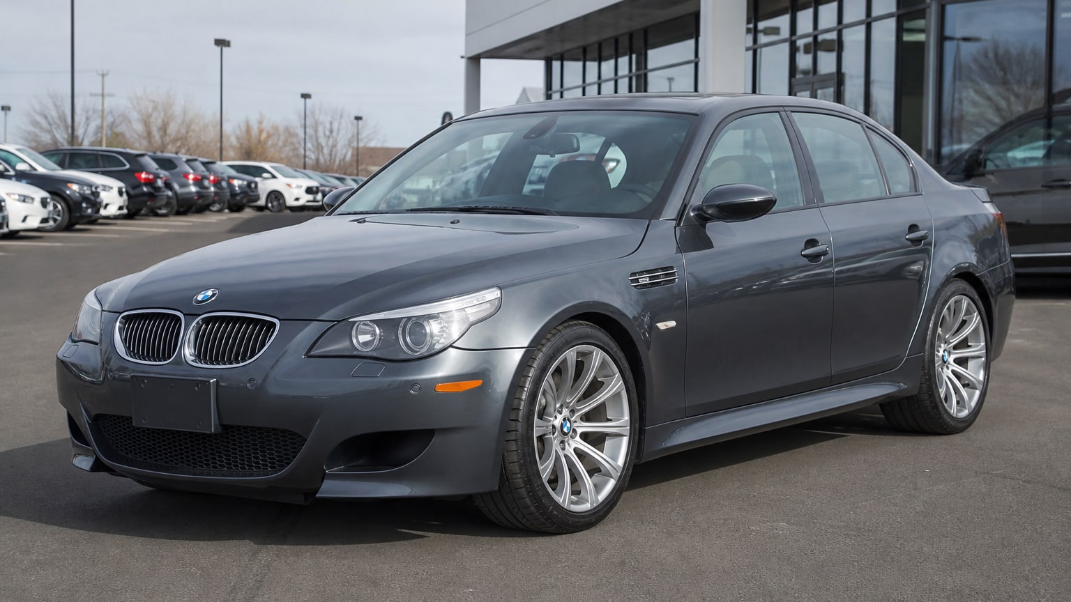 A higher-risk BMW M5 model year parked in a dealership lot.
