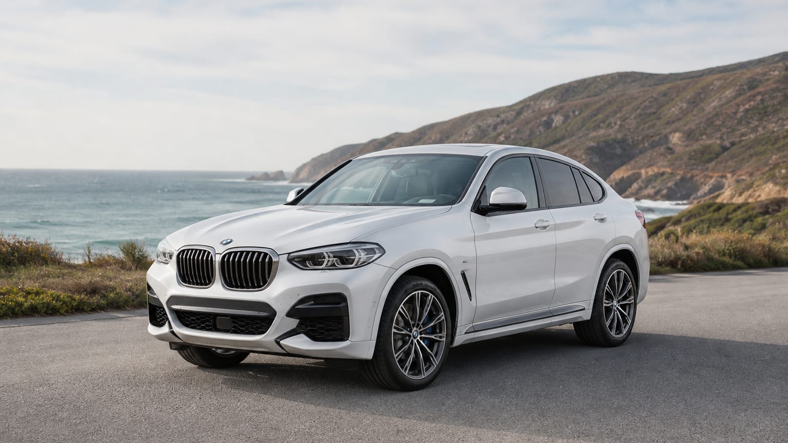A cleaner later-model BMW X4 on a quiet road.