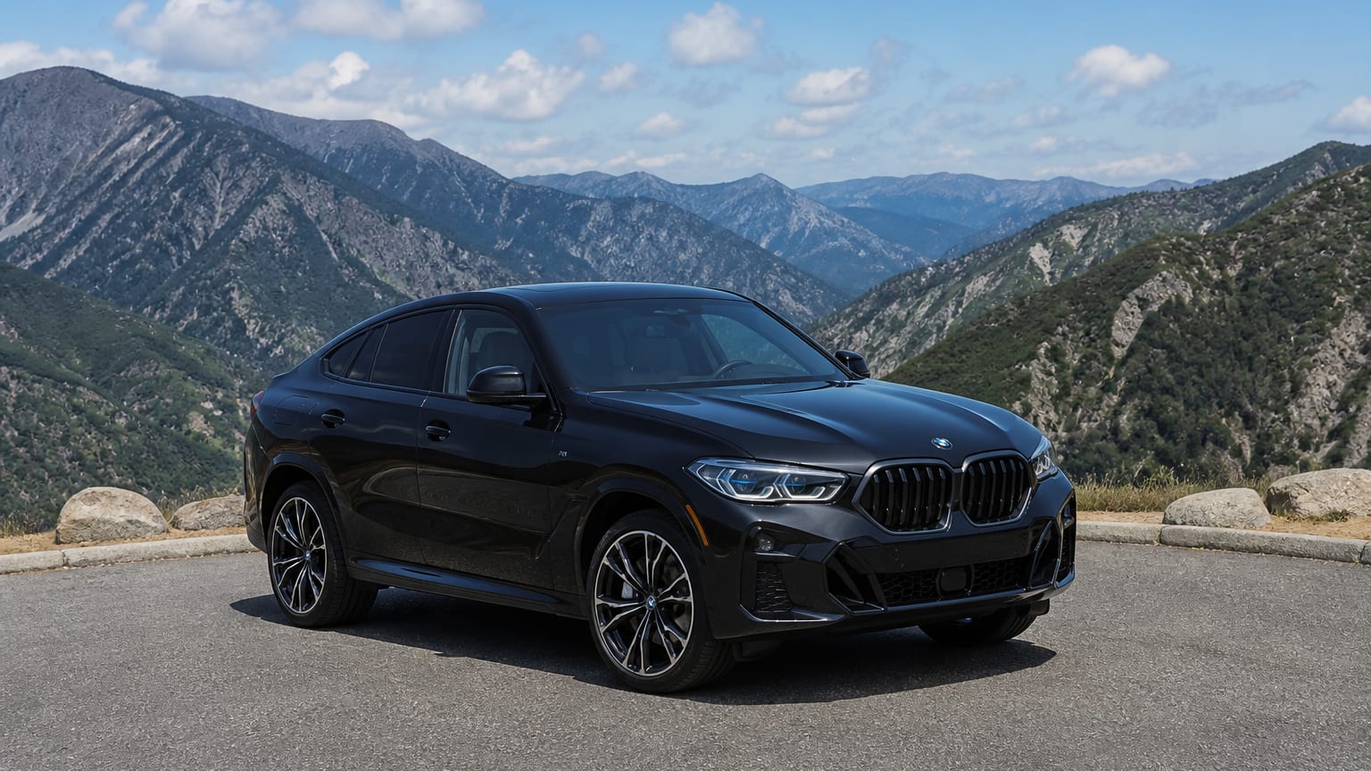 A cleaner later-model BMW X6 on a quiet road.