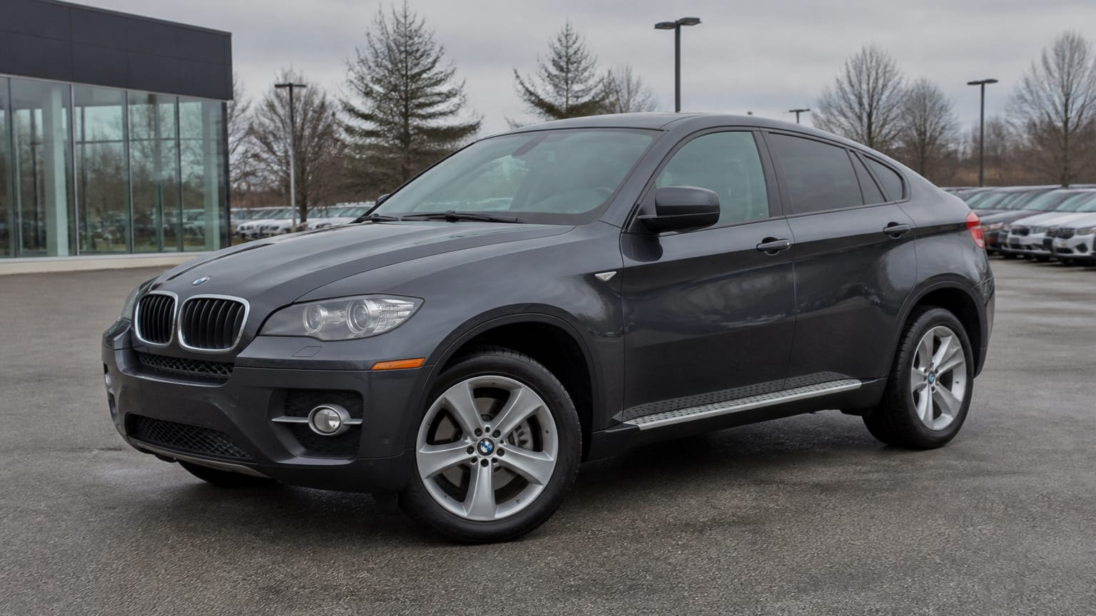 A higher-risk BMW X6 model year parked in a dealership lot.
