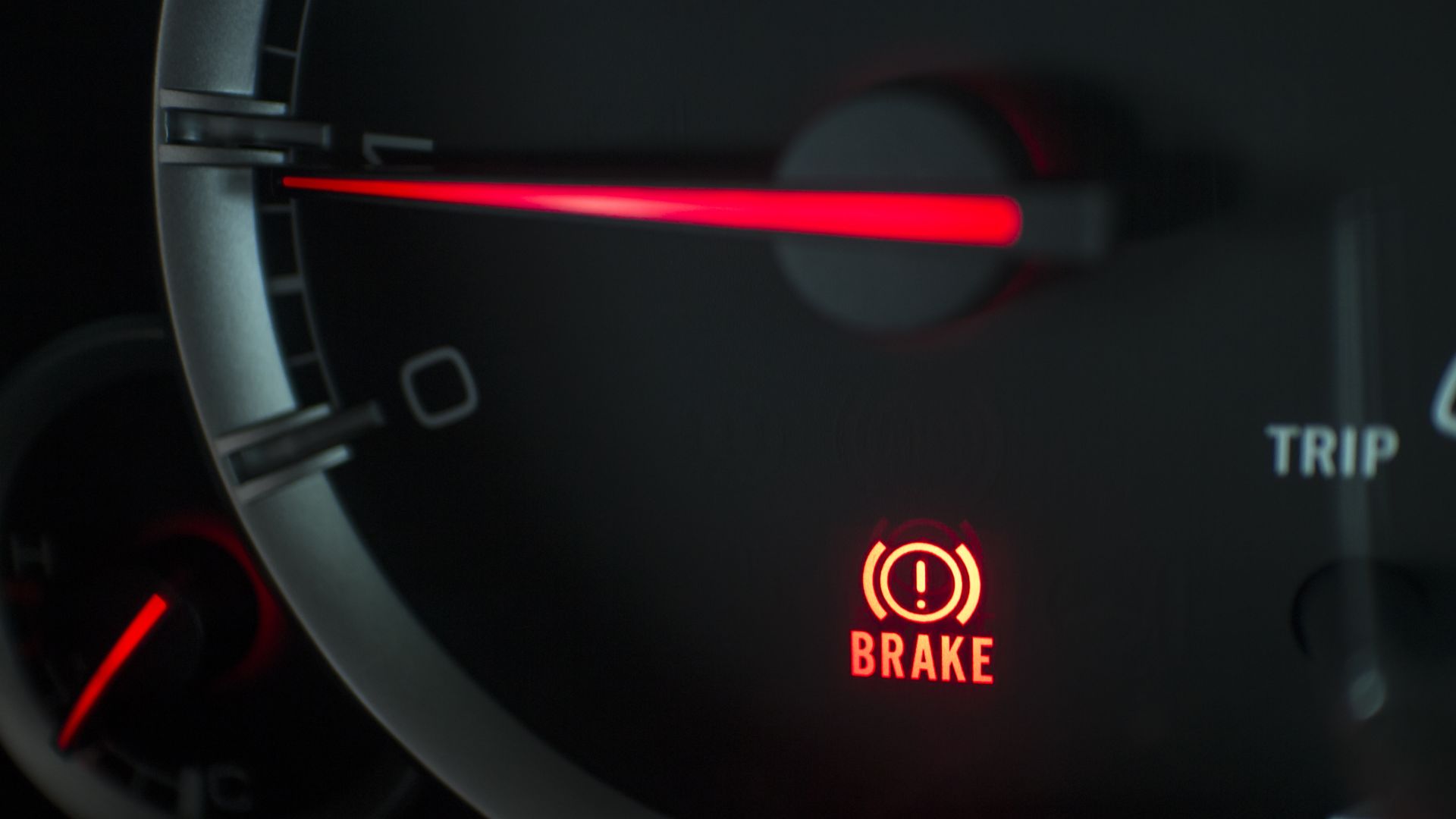 a close up of a car's brake light.|a hand is pressing a button on a car.