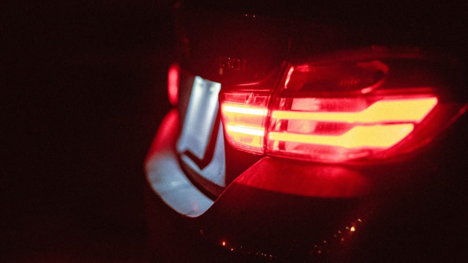 the tail light of a car in the dark.