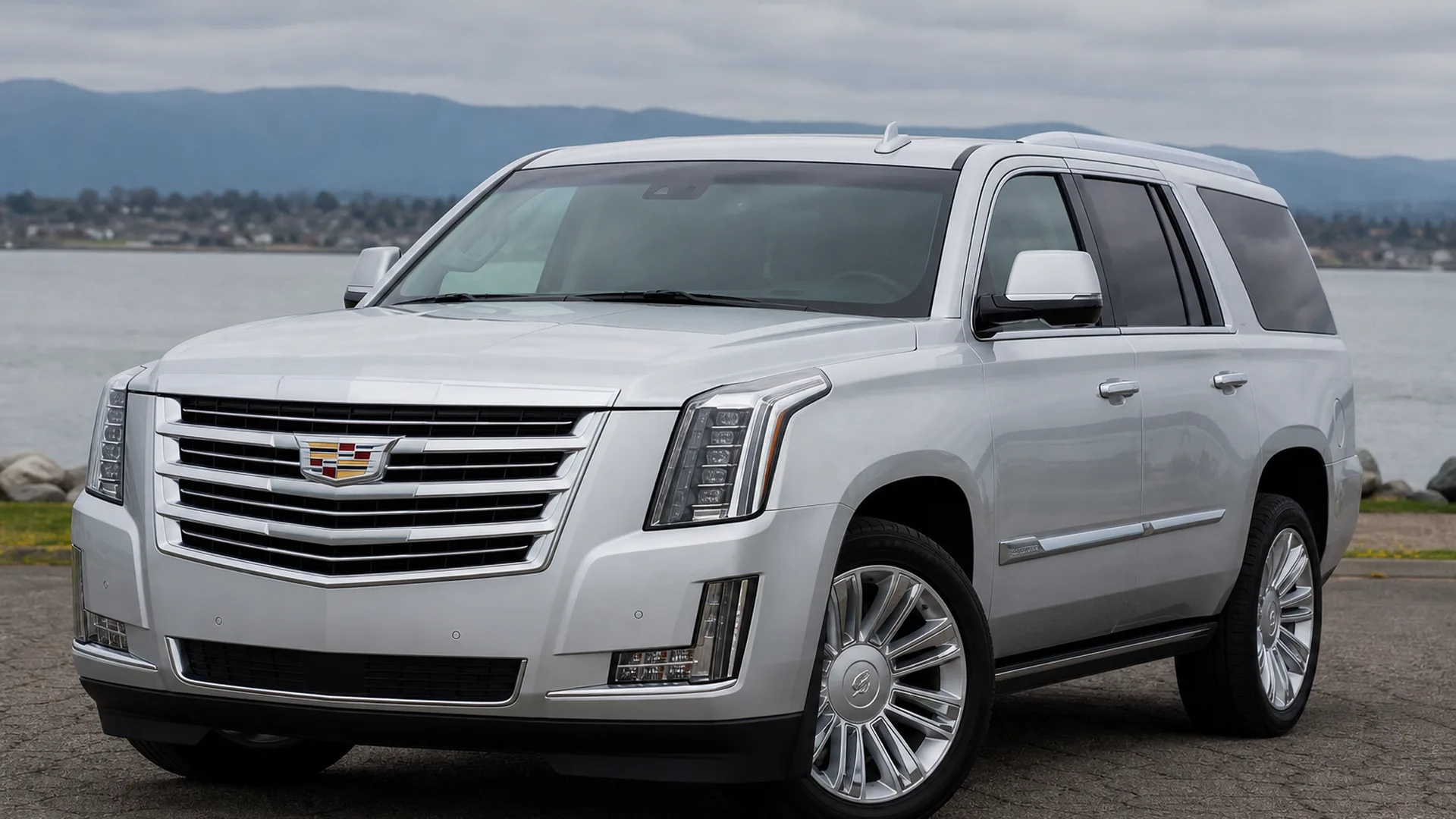 A silver Cadillac Escalade SUV parked outdoors.