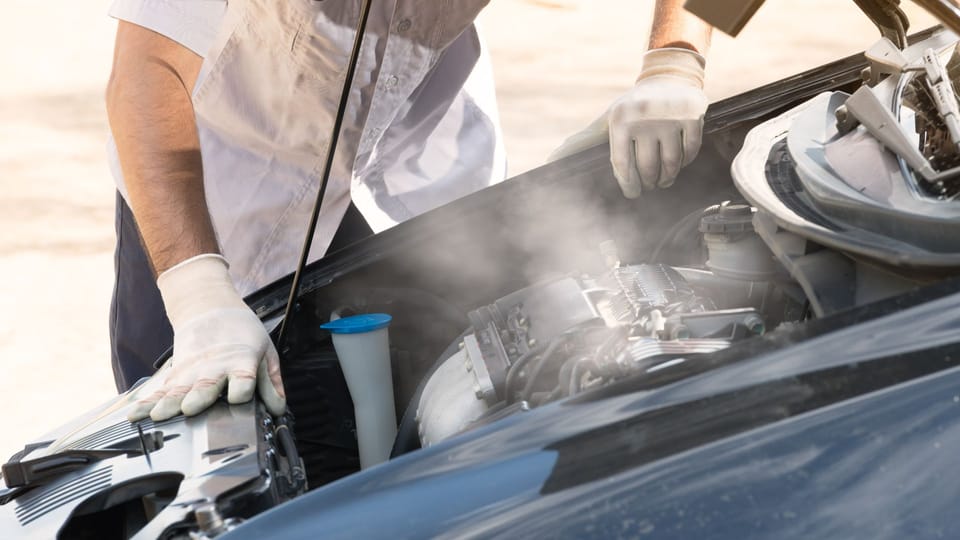 a man in white gloves working on a car engine.|a person holding two gauges in front of a car.|a close up of a propane bottle with a hose connected to it.