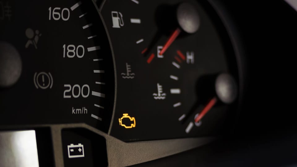 a close up of a speedometer with yellow arrows.