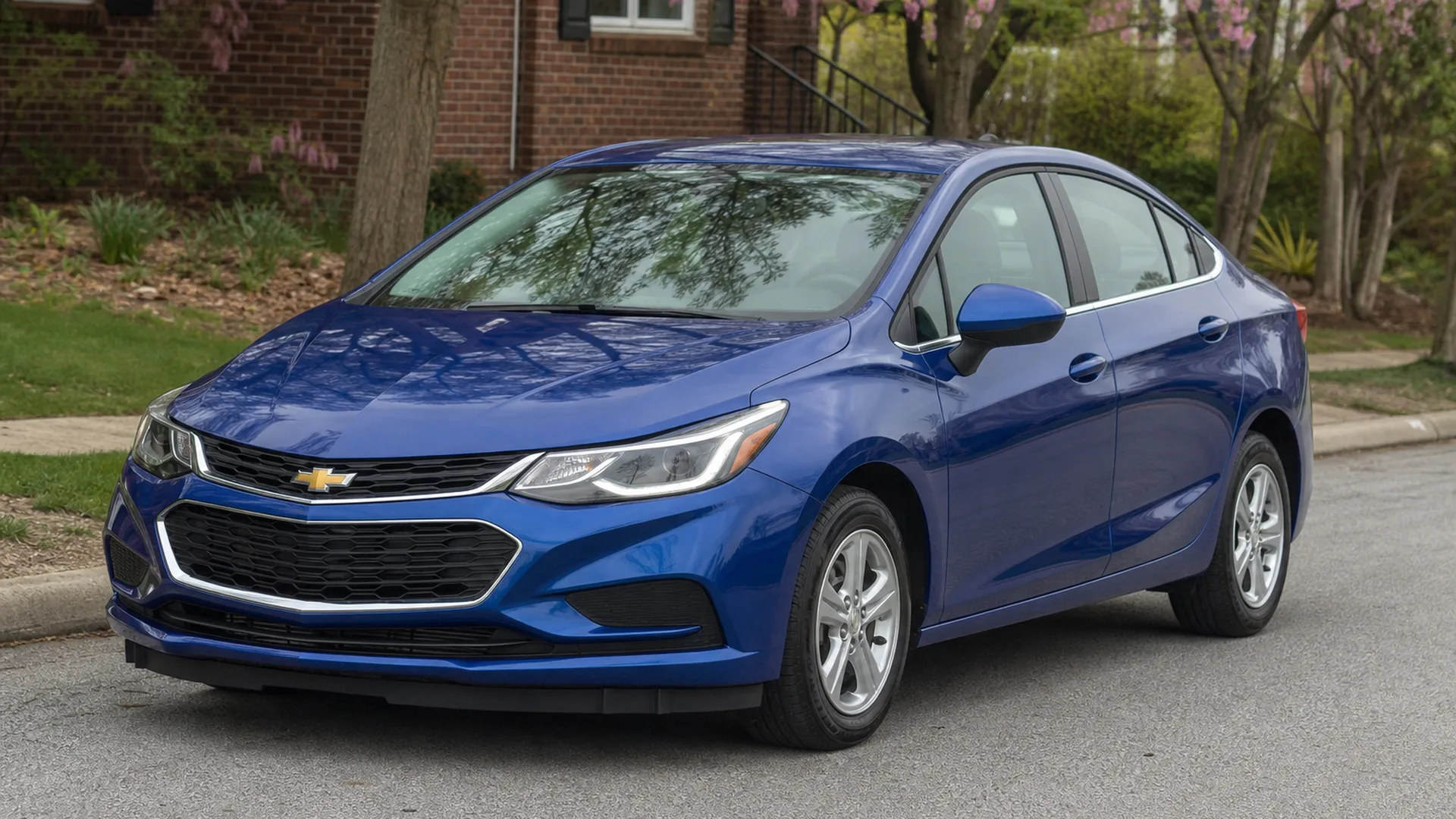 A blue Chevrolet Cruze sedan parked on a street.