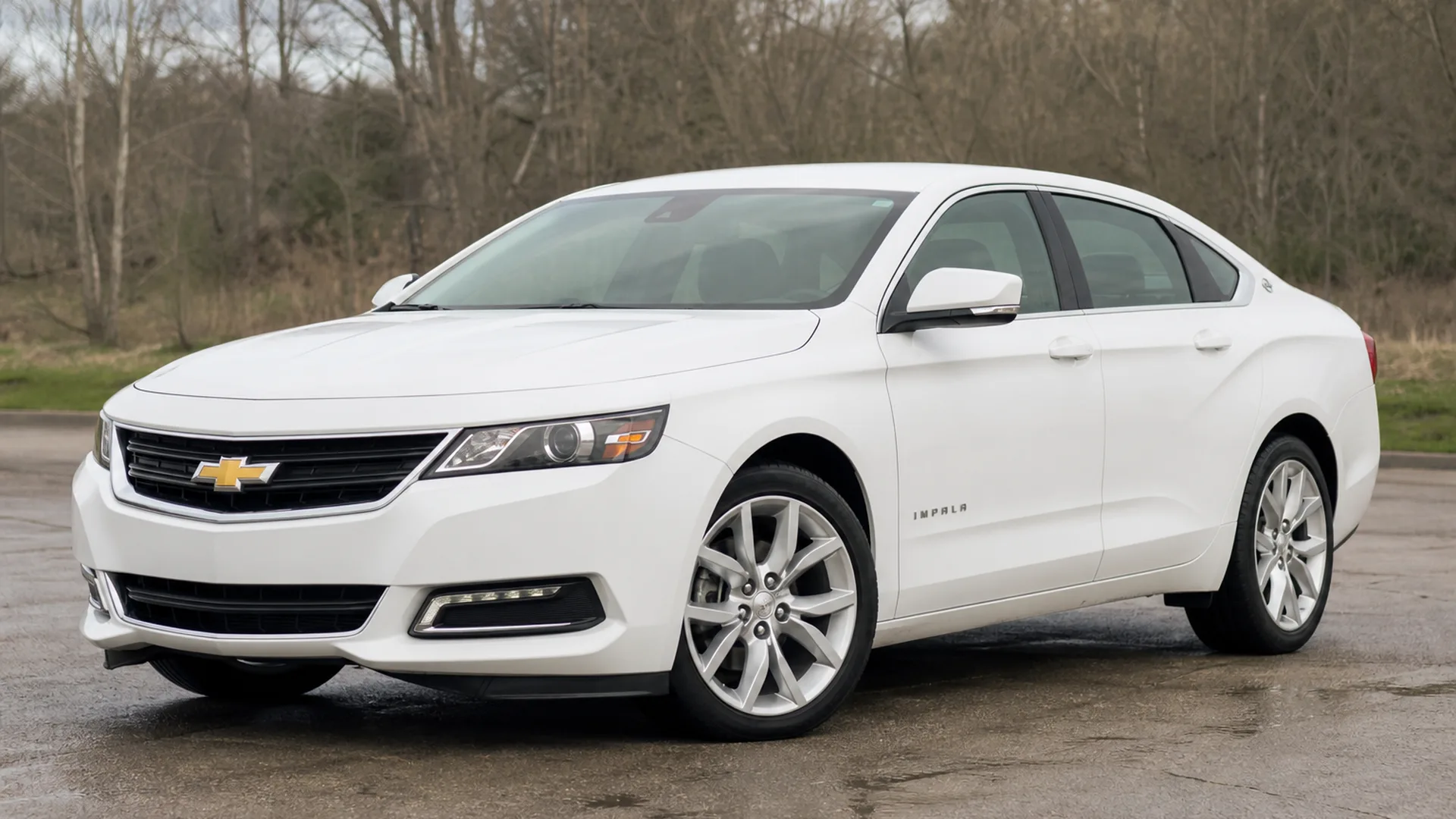 A white Chevrolet Impala sedan parked outdoors.