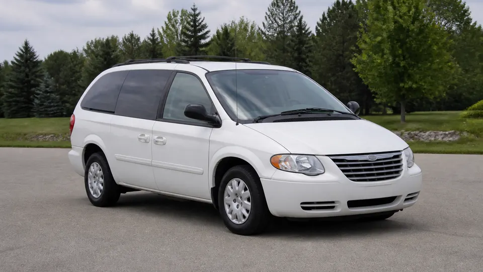 A Chrysler Voyager minivan, three-quarter front view, parked outdoors.