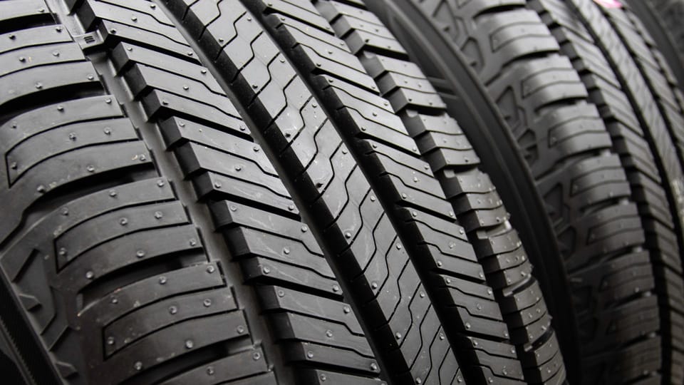 a row of tires sitting next to each other.|a close up of a tire on a car.