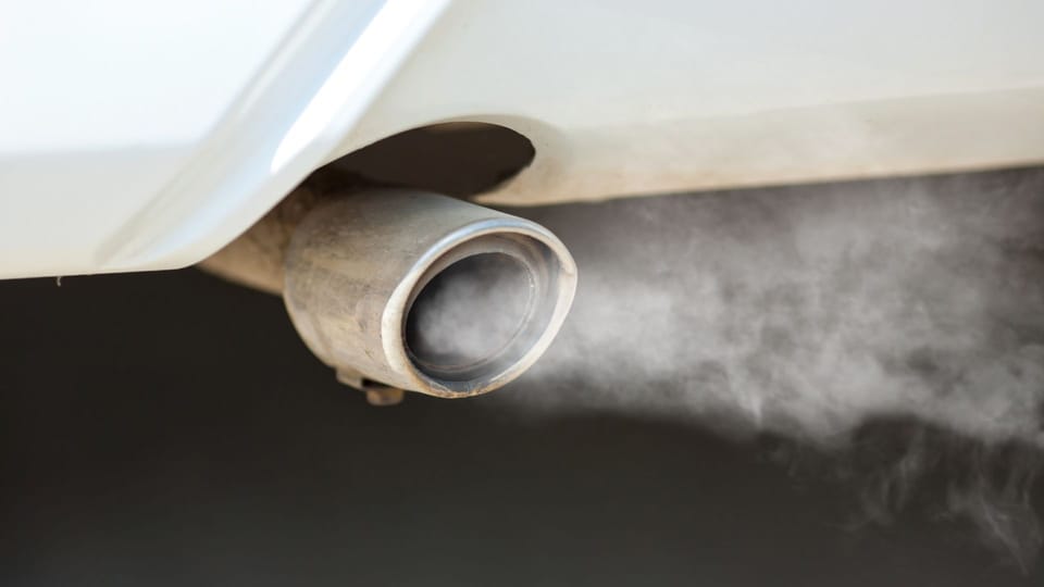 smoke coming out of the exhaust pipe of a car.|smoke coming out of the exhaust pipes of a car.
