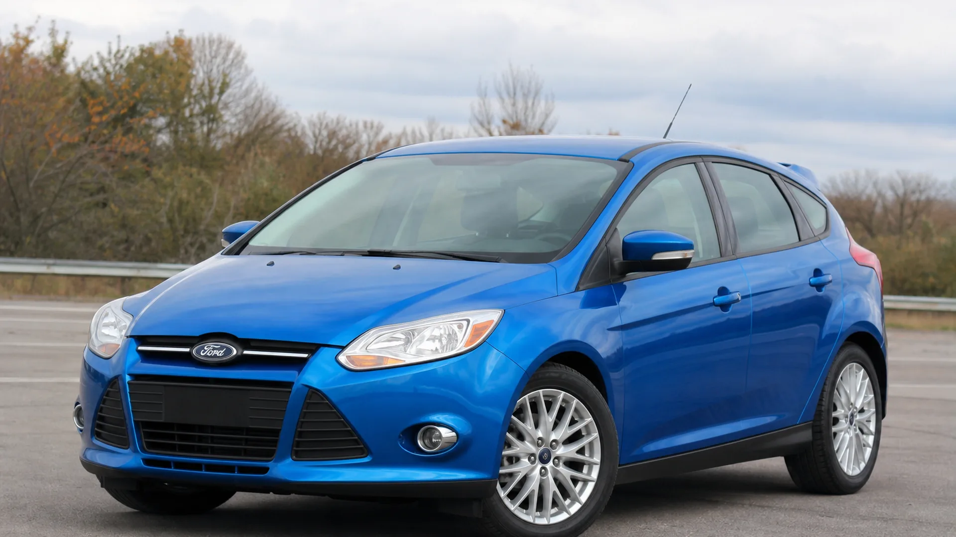 A blue Ford Focus hatchback parked outdoors.
