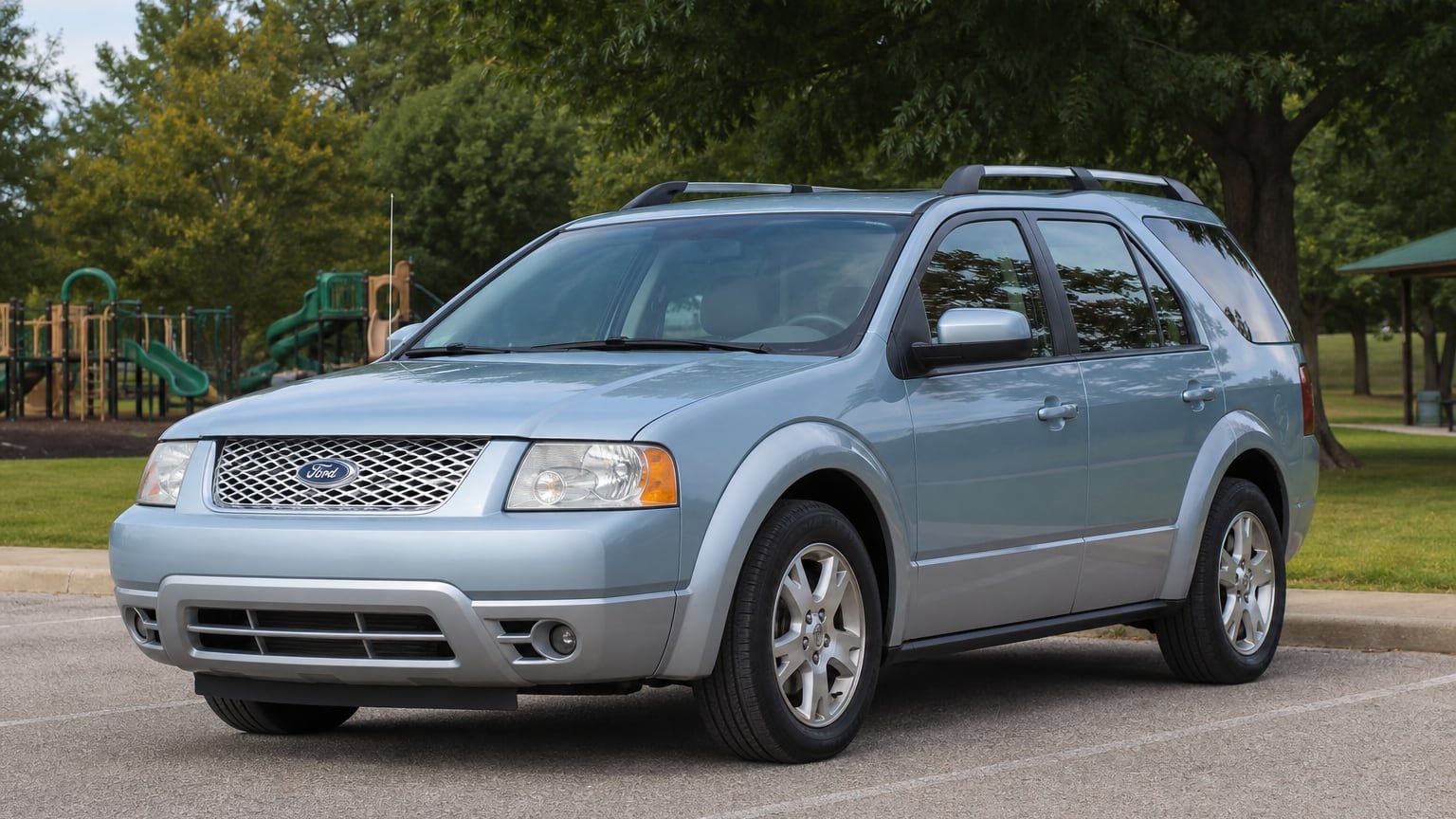 A silver mid-2000s Ford Freestyle three-row crossover parked at a park lot.