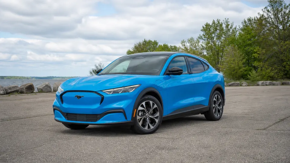 A Ford Mustang Mach-E electric crossover, three-quarter front view, parked outdoors.
