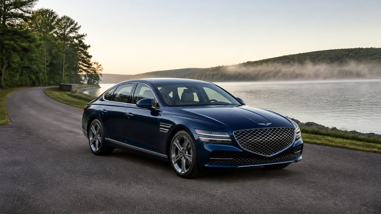 A cleaner later-model Genesis G80 on a quiet road.