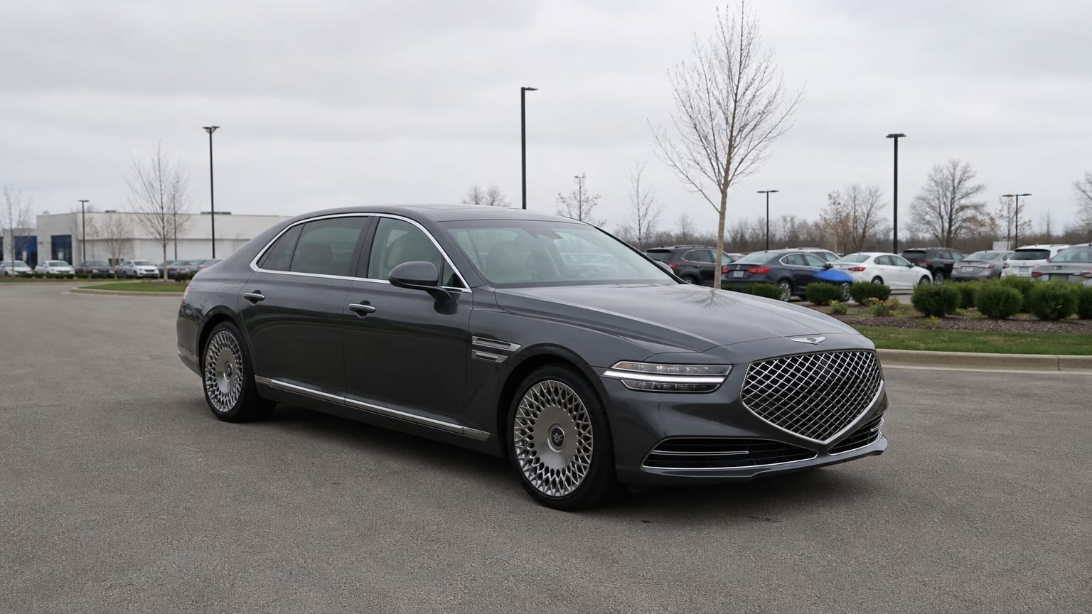 A higher-risk Genesis G90 model year parked in a dealership lot.