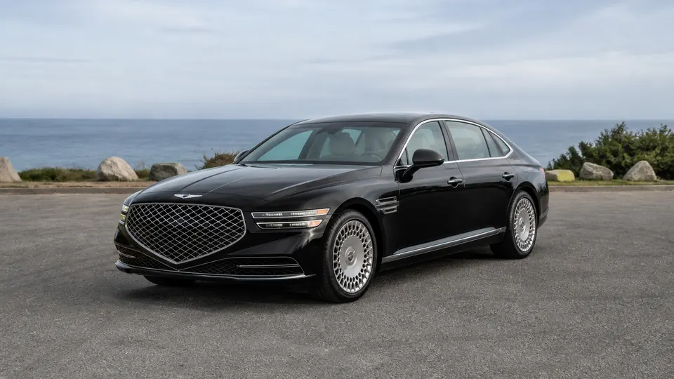A Genesis G90 sedan, three-quarter front view, parked outdoors.