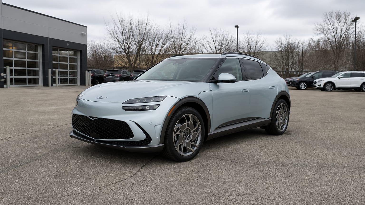 A higher-risk Genesis GV60 model year parked in a dealership lot.
