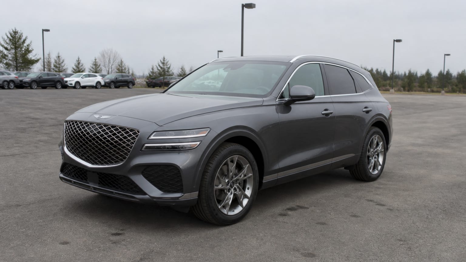 A higher-risk Genesis GV70 model year parked in a dealership lot.