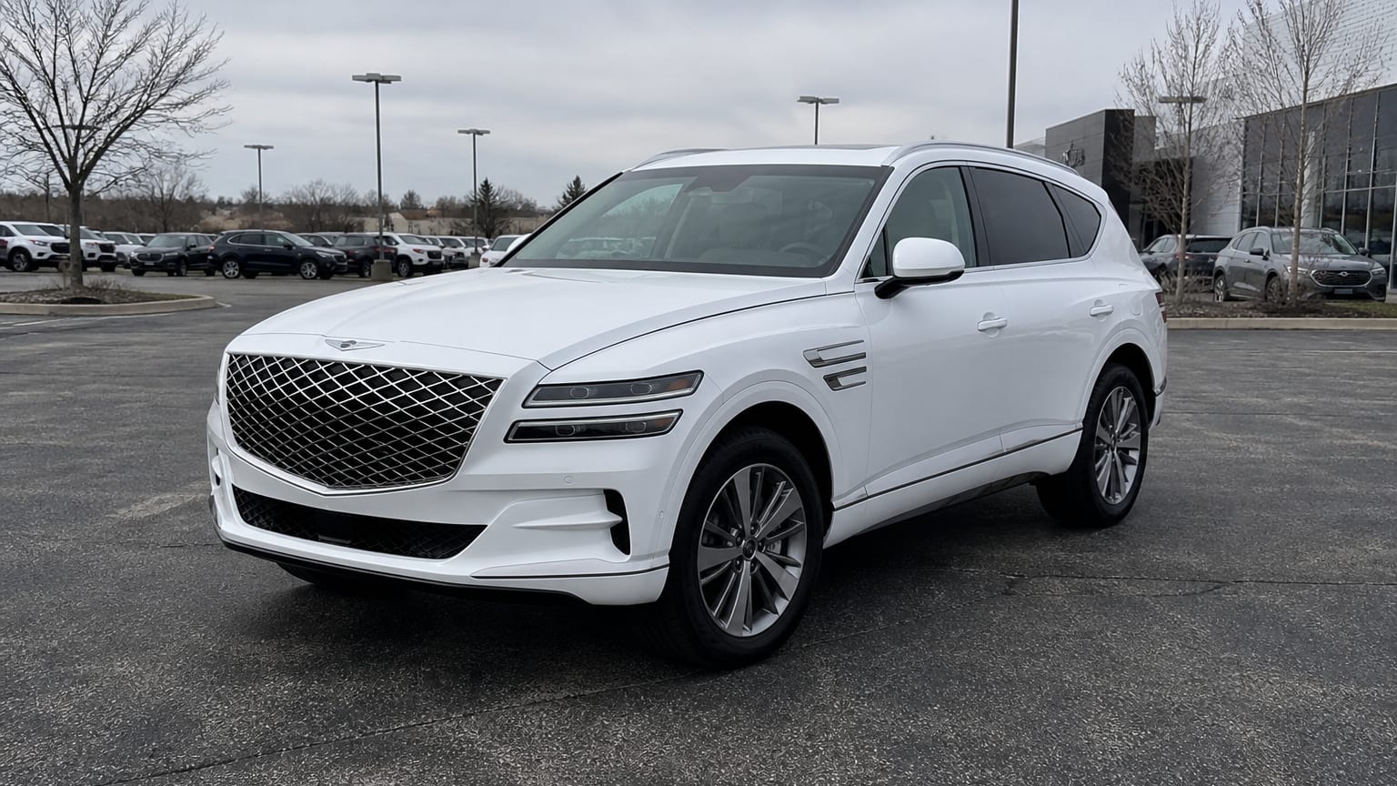 A higher-risk Genesis GV80 model year parked in a dealership lot.