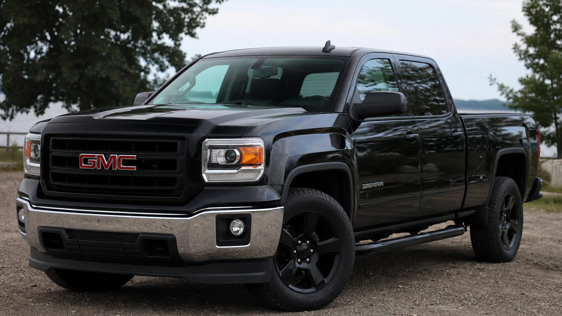 A black GMC Sierra pickup truck parked outdoors.