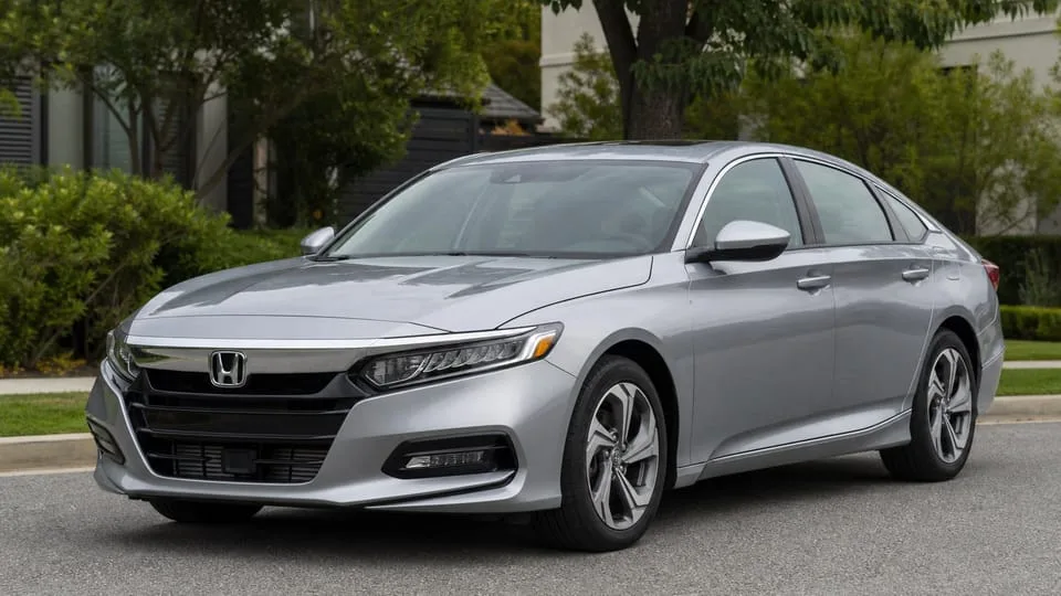 A silver Honda Accord sedan parked on a residential street.