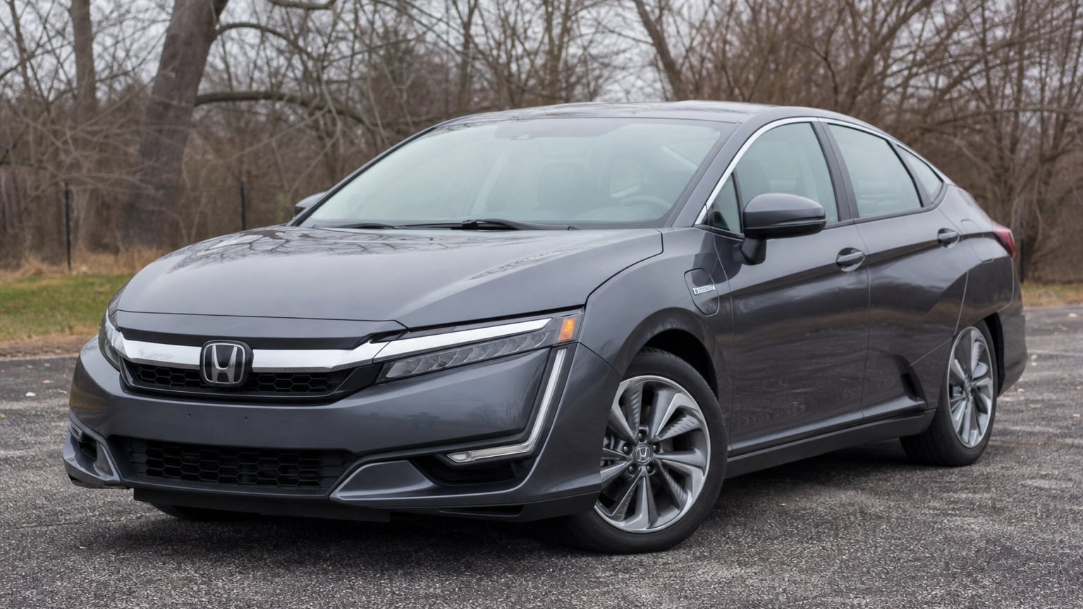 A dark blue early Honda Clarity Plug-In Hybrid sedan parked outdoors.
