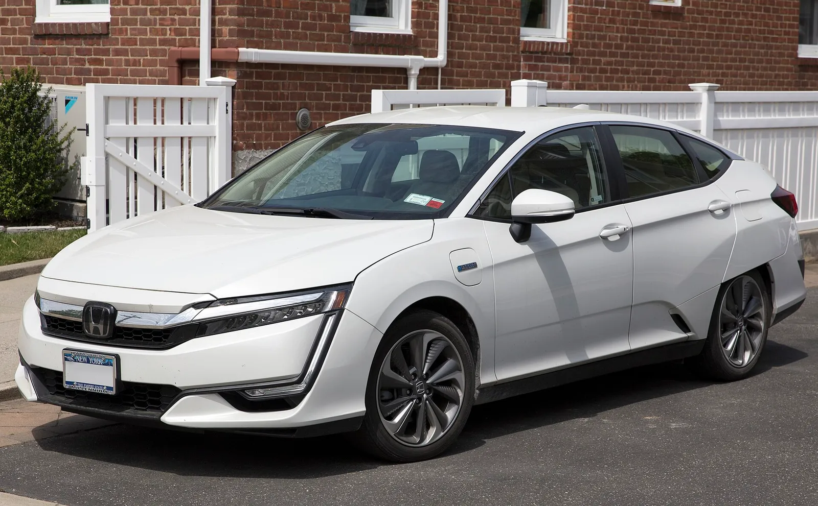 A white 2021 Honda Clarity Plug-In Hybrid sedan parked outdoors.