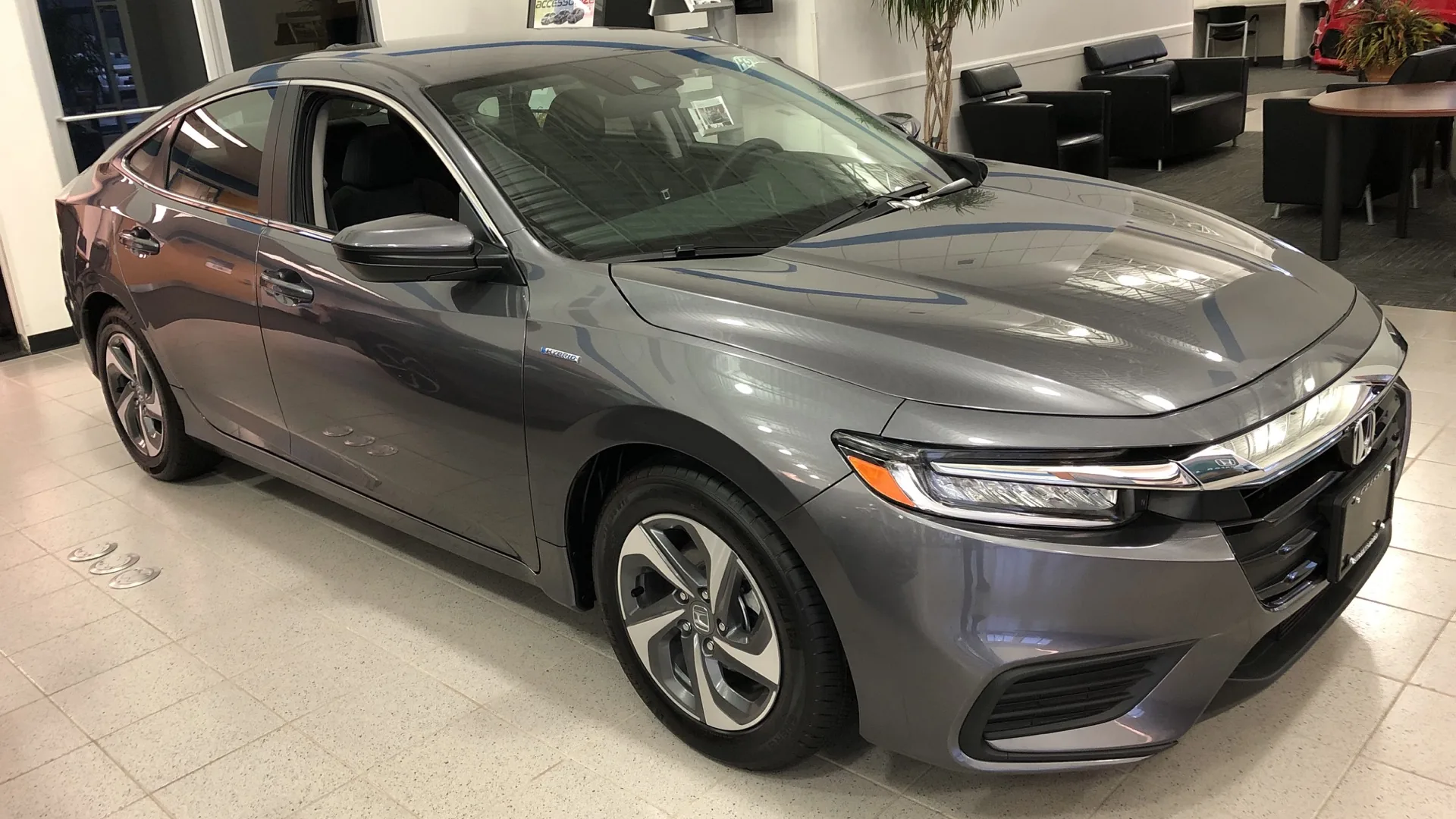 A silver 2019 Honda Insight hybrid sedan parked outdoors.