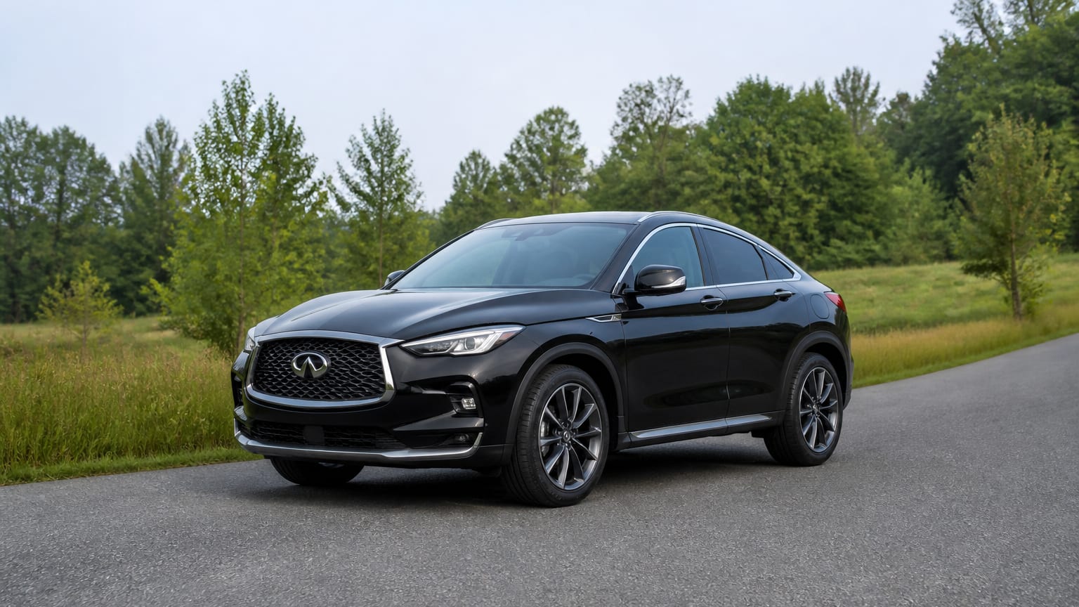A cleaner later-model Infiniti QX55 on a quiet road.