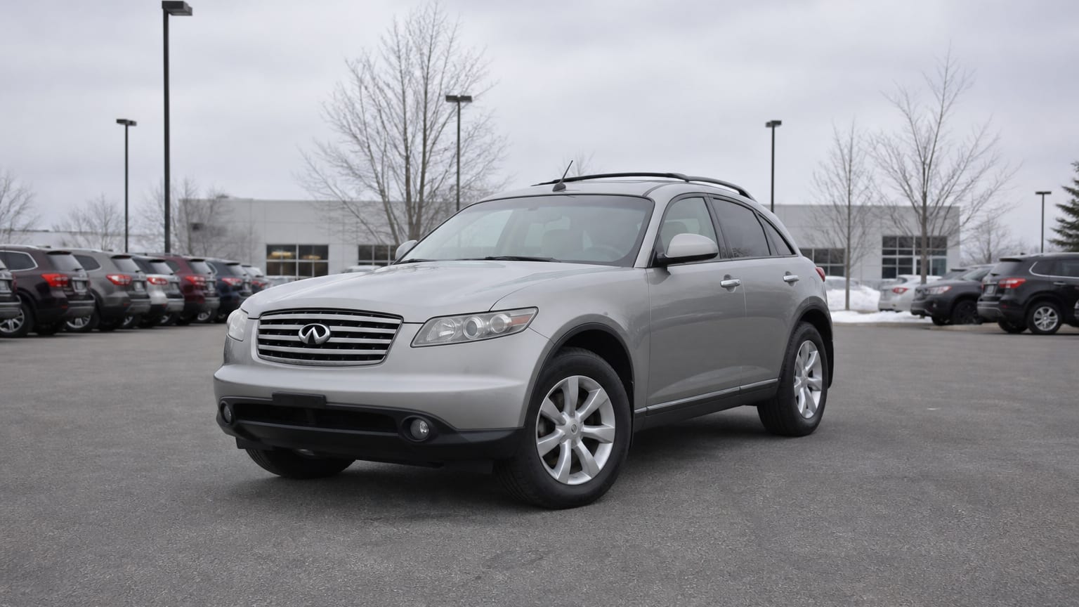 A higher-risk Infiniti QX55 model year parked in a dealership lot.