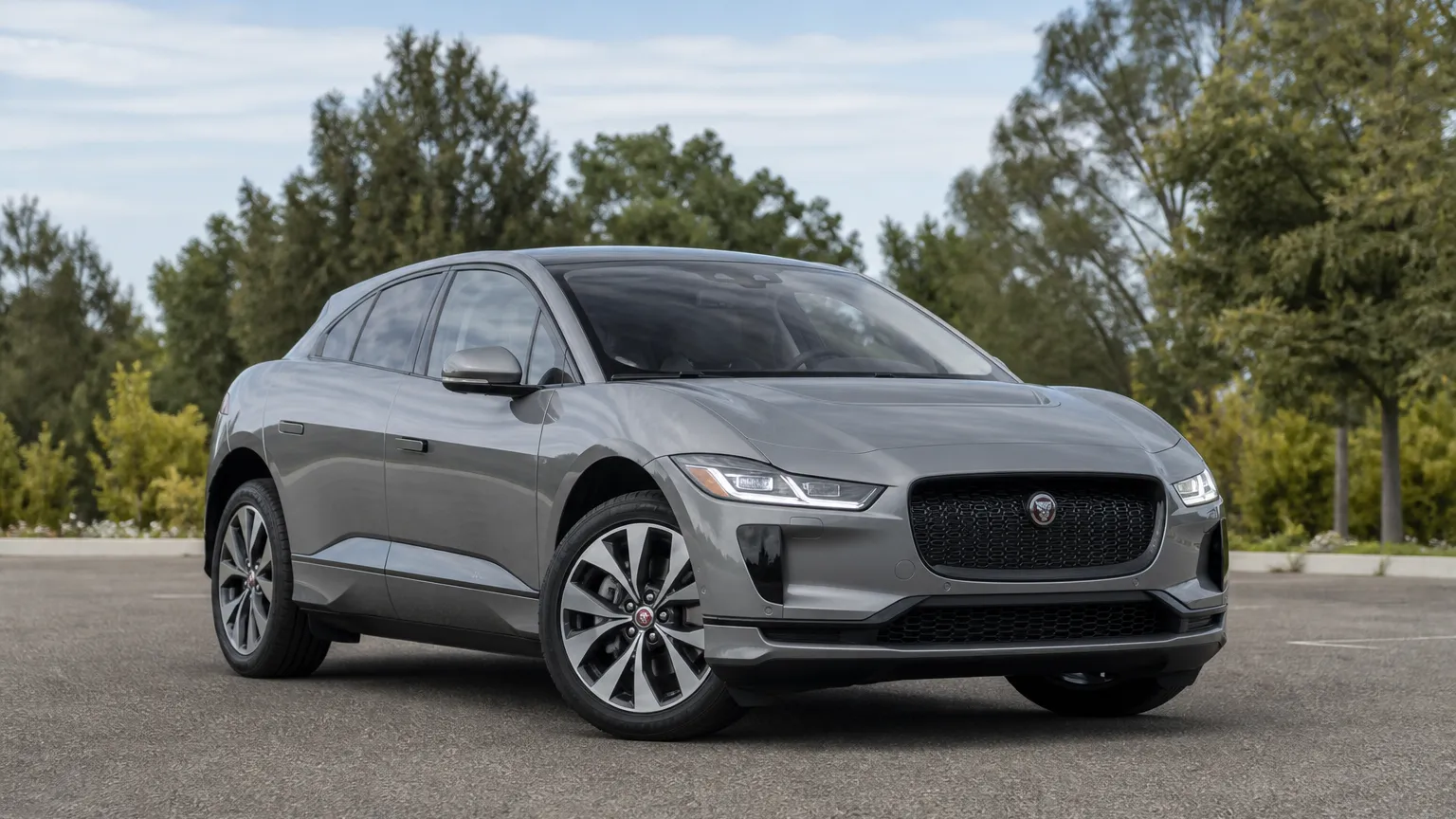 A Jaguar I-Pace electric SUV, three-quarter front view, parked outdoors.